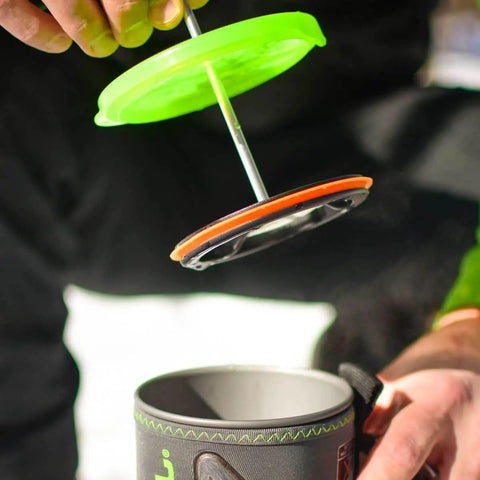 Close-up of Silicone French Press Coffee Maker For Camping Stoves Regular Size in use with secure silicone ring, compatible with Jetboil.