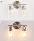 Two Light Brushed Nickel Bathroom Vanity Light with clear glass shades shown on and off, indoor wall sconce fixture.