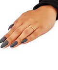 Real Deal 0.15 Ctw Genuine Round Cut Diamond Wedding Band Encased In Solid 14K Yellow Gold Machine Set on a hand with black nails.