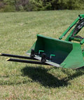 Light Duty Clamp On Pallet Forks, 43 Inch Overall Length, attached to a green loader bucket on grass, universal fit