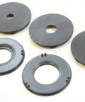 Precision Router Table Insert Ring Set With Straight Up Tough Build Quality For Three Inch Outer Diameter Flush Fit and Lightning Quick Swap Setup On Classic Router Tables Total Shop Upgrade For Real Deal Woodworkers, displaying multiple black insert rings.