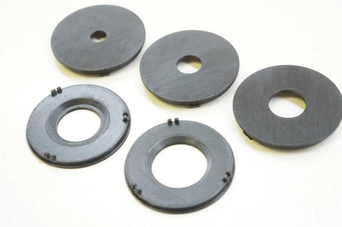 Precision Router Table Insert Ring Set With Straight Up Tough Build Quality For Three Inch Outer Diameter Flush Fit and Lightning Quick Swap Setup On Classic Router Tables Total Shop Upgrade For Real Deal Woodworkers, displaying multiple black insert rings.