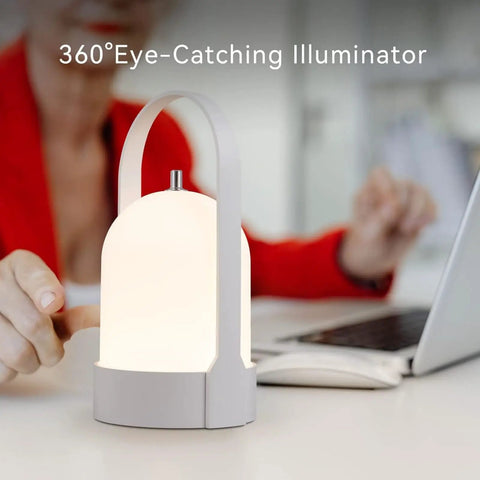 All Day 4000mAh Rechargeable LED Lantern Table Lamp With Cordless Power shown glowing on a desk beside a laptop.