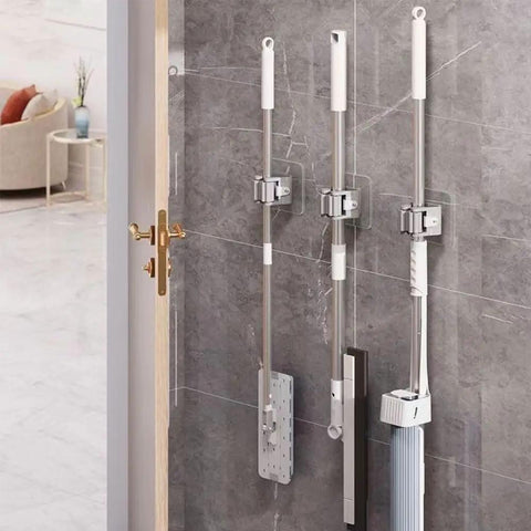 Heavy Duty Wall Mount Broom And Mop Holder Organizer For Home Garage Laundry with three tools on gray wall