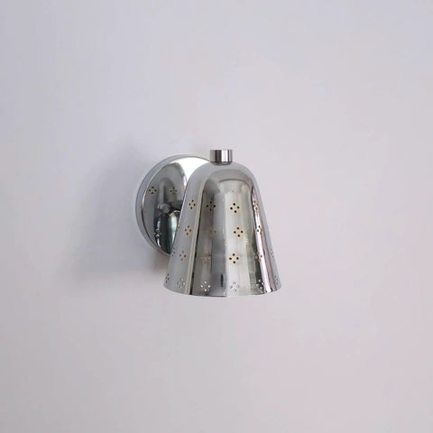 Silver Brass Wall Sconce, Mid Century Cone Lamp, Perforated Spotlight mounted on white wall with intricate perforation design.