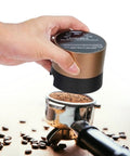 Next Level Electric Coffee Distributor And Tamper Tool With Rock Solid Precision For 58mm Portafilter Baskets in use, hand operating.