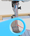 Close-up of Quick Automatic Needle Threader For Sewing Machine 3 In 1 Multitool with magnifier threading needle on sewing machine.
