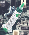 Light Curing Solder Mask Ink For PCB Repair, syringe with green ink on electronic circuit board.