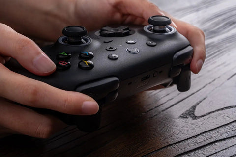 Hands holding Wireless Gaming Controller For Windows PC Mac Steam And Android With TMR Joysticks Hall Triggers Motion Control RGB Fire