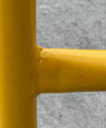 Close-up of welded joint on Dead Easy Osha Compliant Industrial Safety Railing With Vivid Yellow Finish.