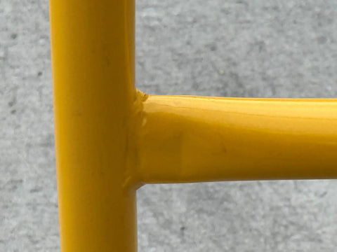 Close-up of welded joint on Dead Easy Osha Compliant Industrial Safety Railing With Vivid Yellow Finish.