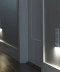 Two Pack MotionLight Built In Wall Plate LED Night Lights For Duplex Outlets With Auto On Off Sensor illuminated in hallway.