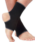 Person wearing Open Heel Ankle Support Sleeve With Light Breathable Knit Fabric For Men Women Kids Medium Compression Right Or Left Ankle Black Size M 1 Pair Ideal For Running Basketball Tennis MMA Ultra Comfortable All Day Sport Wear on right ankle, showcasing flexible open heel design and breathable fabric texture.