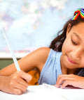 Child writing with Rainbow Paper Pencils Set 24 Pieces Number 2 HB Graphite Pencils With White Barrels in a classroom.