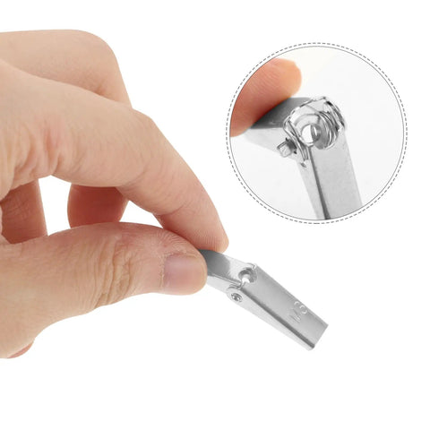 Close-up of a hand holding a galvanized steel drywall toggle anchor, showing toggle wing nut fasteners detail