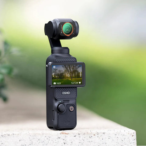 Close-up of DJI Osmo Pocket 4/3 camera with Osmo Pocket 4x3 Magnetic CPL Filter, capturing vibrant outdoor scene.