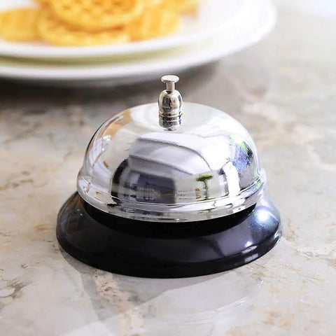 Desk Bell For Service And Reception With Ring Sign, Clear Call Bell For Front Desk, Office, Hotel, Hospital, School, Dinner Bell, Easy To Use, Loud Ring, Double-Sided Sign For Assistance. Chrome stainless steel desk bell with black base on countertop.