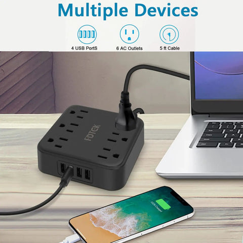 2 Prong To 3 Prong Outlet Adapter With 4 USB Ports And 6 AC Outlets Desktop Charging Hub on desk next to laptop and charging phone.