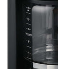 Close-up of 12-Cup Touchscreen Coffee Maker With Glass Carafe, showing measurement markings for brew strength control and iced coffee mode.