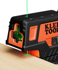 Compact Self Leveling Laser Level With Plumb Spot, Bright Green Cross Lines, 75 Foot Range, Class 2 Laser on wooden surface