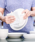 Person using Lint Free 100 Percent Cotton Cleaning Rags 15 Pack 18x18 White Cloths for dishes and cleaning surfaces.