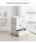 Stackable Plastic Storage Box With Lid For Desk Organization White PP Bin shown stacked and open with stationery inside.