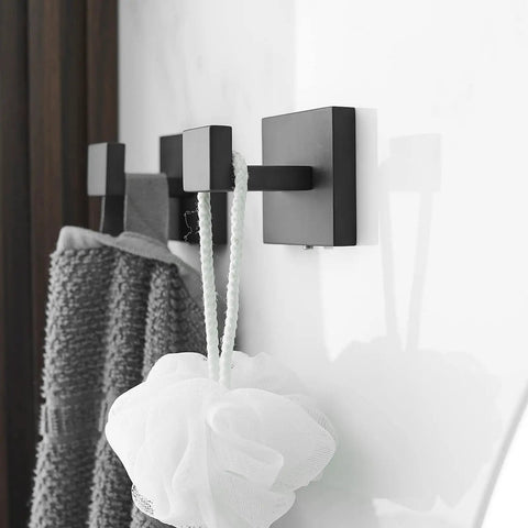 Four Piece Black Stainless Steel Bathroom Accessory Set With 23.6 Inch Towel Bar 8.2 Inch Towel Bar Toilet Paper Holder And Hooks Wall Mounted For A Sleek Dope Home Upgrade featuring black wall-mounted hooks holding towel and sponge