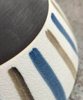 Close-up of the DWEIHDV Ceramic Wall Sconce Vintage Gold Wall Light Fixture showing hand-painted striped ceramic shade.
