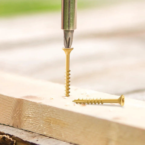Top Shelf Rock Solid Deck Screws Ten Gauge By Three And A Half Inch Wood Fasteners Tan Epoxy Coated for maximum rust resistance being drilled into wood.