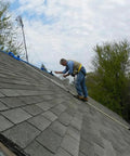 Worker using Heavy-Duty Roof Safety Anchor For First Man Up And Last Man Down, 5,000-Lb Capacity on steep-slope asphalt roof.
