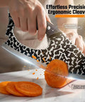 Two Pack Hand Forged Chef Knife And Cleaver Set cutting carrot on marble surface, ergonomic grip visible.
