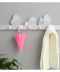 Solid Wooden Wall Mounted Coat Rack With Key Holder Smooth Black Finish Multi Purpose Entryway Organizer For Coats Hats Towels No Sweat Setup Straight Up Top Shelf Storage with pink umbrella and white towel.