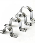 Angled view: set of four stainless steel conduit clamps, 3/4 inch (20mm), two-hole U brackets for pipe fixing on surfaces