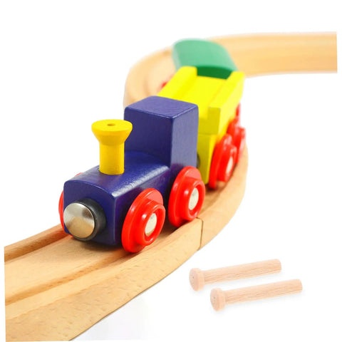 Colorful wooden toy train on tracks with two miniature wooden T nails for crafts and woodworking displayed beside it.