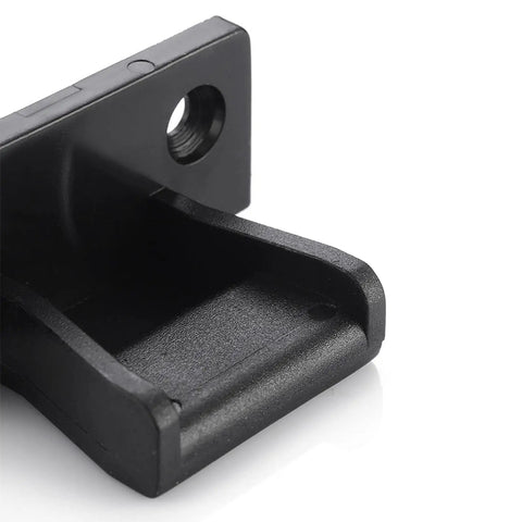 Close-up of heavy duty concealed panel fastener for kitchens, black plastic, designed for secure snap lock mounting.