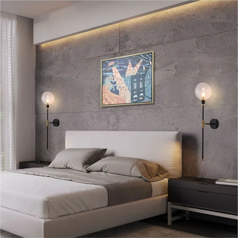 Industrial Gold And Black 1 Light Wall Sconce With Long Arm And Globe Glass Shade Delivers A Lit Glow Modern Wall Mounted Lamp For Bedroom Hallway Clear Glass Set Of 2 installed above bed against concrete wall
