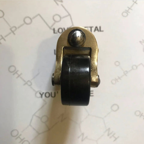 Heavy Duty Brass Rubber Caster Wheels For Furniture Move Like Butter Swivel Replacement Casters With Vintage Cup Base and Screw Mount Silent Glide For Beds and Sofas, top view of caster with black wheel.