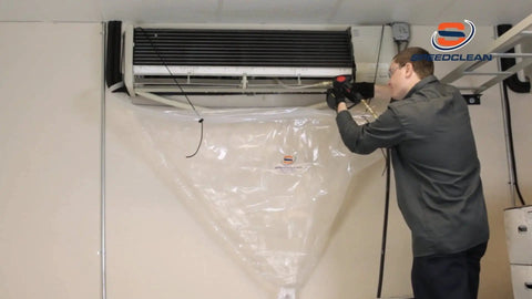 Technician using Mini Split Bib Kit for cleanups that catch water and coil cleaner with no mess protect walls and floors from over spray