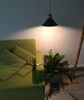 3-Light Battery-Powered LED Pendant Kit With Remote Control illuminating a sofa and plant, black retro finish