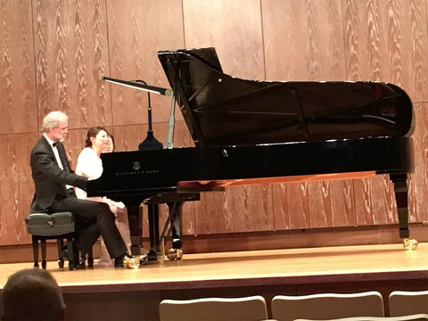 Grand piano with musicians, illuminated by Wide 21.26 Inch Piano Lamp With LED Light Panel, Eye-Caring, Stepless Dimming, in concert setting.