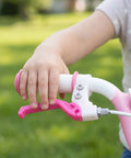 Child hand using Kids Bike Brake Lever Set, 2 Pack Universal Brake Handles for Kids Bikes, rosy plastic levers on handlebars