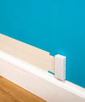 Ultra Flat Adhesive Speaker Wire 16 Gauge 2 Conductor 100 Foot White Spool For Concealed Audio Installations on blue wall