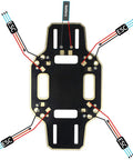 Top view of a 330mm 4 Axis Quadcopter Drone Frame Kit for DIY Drones with integrated PCB connections and ESC labels.