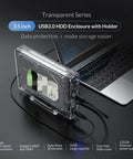 Transparent Usb 3.0 To Sata Hard Drive Enclosure Docking Station for 3.5 inch SSD HDD with holder on a desk.