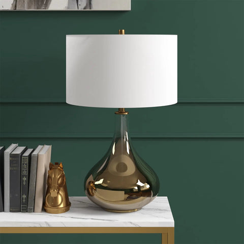 25.5 Inch Tall Table Lamp With White Fabric Shade And Smoked Chrome Glass Base on marble top next to books in contemporary decor