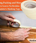 Person applying painter's masking tape along a floor edge to prevent paint spills, ideal for crisp finishes. Seamless Paint Roller Brush With Integrated Flocked Edger Skip The Masking Tape For A Crisp Pro Level Edge Just Pour And Paint Any Interior Wall Quick Drying Low Odor Formula Makes Nailing Your Diy Projects A Breeze Today.