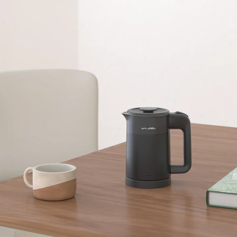 Grab And Go 0.6L Electric Kettle For Travel Ultralight 1.34lb 600W Fast Boil Double Wall Stainless Steel Auto Shut Off Portable Tea And Coffee Kettle Black on table