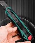 Tough As Nails Heavy Duty Tin Snips And Industrial Scissors With Serrated Stainless Blade Ergonomic Handles For Sheet Metal Cable Notch Leather Fabric Cutting Seven Eight Inch Straight Edges utility knife in hand, showing safety features.