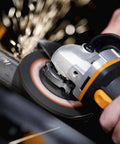 No Hassle Heavy Duty Cordless Angle Grinder With 20 Volt Lithium Ion Battery compactly grinding through metal with sparks flying.