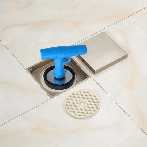 Blue plastic floor drain cleanout plug with T-handle in stainless steel floor drain